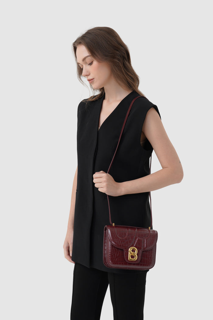 alba bag croco in burgundy by buttonscarves worn as sling bag