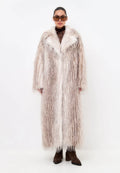 A fashionable women's long faux fur coat with a belt, perfect for winter and adding style to any outfit.