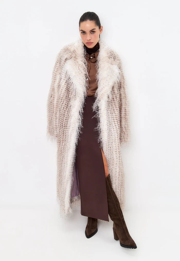 A stylish long belted faux fur coat in winter fashion for women.