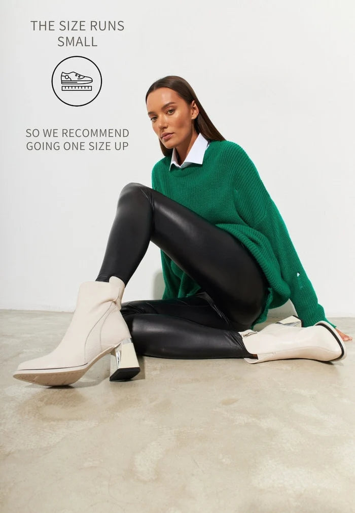 A trendy pair of off white block heel ankle boots for women, featuring a chunky heel and stylish design - perfect fashion ankle boots for any outfit.