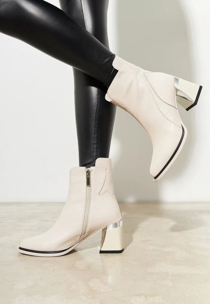 A stylish pair of off white block heel ankle boots for women, featuring a chunky heel and a trendy design perfect for fashion-forward looks.