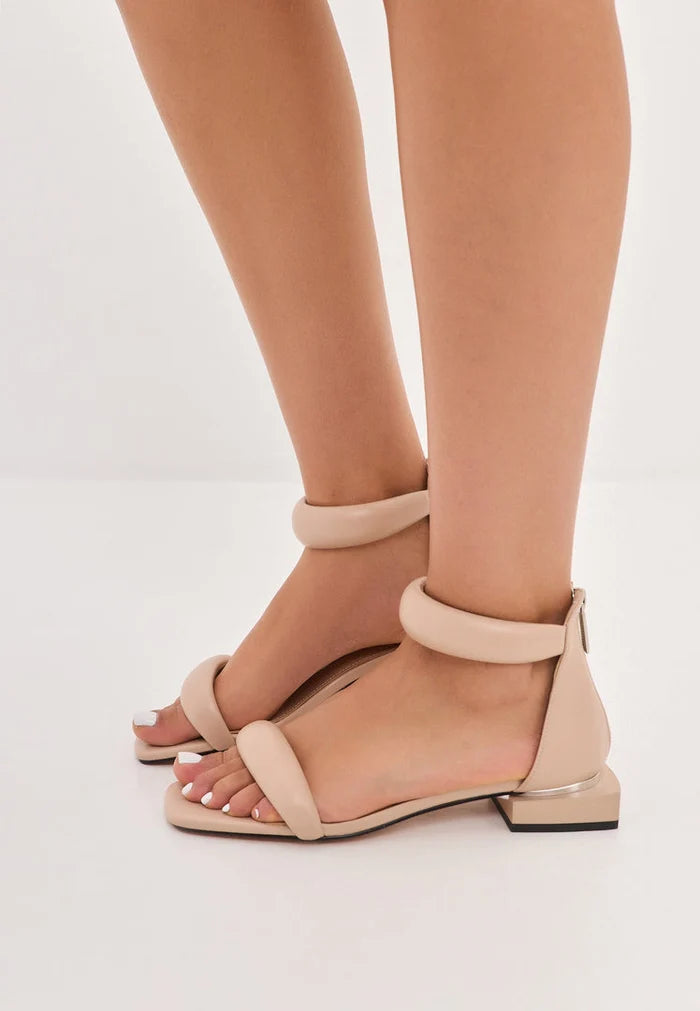 A pair of stylish beige block heel sandals, perfect for everyday wear.
