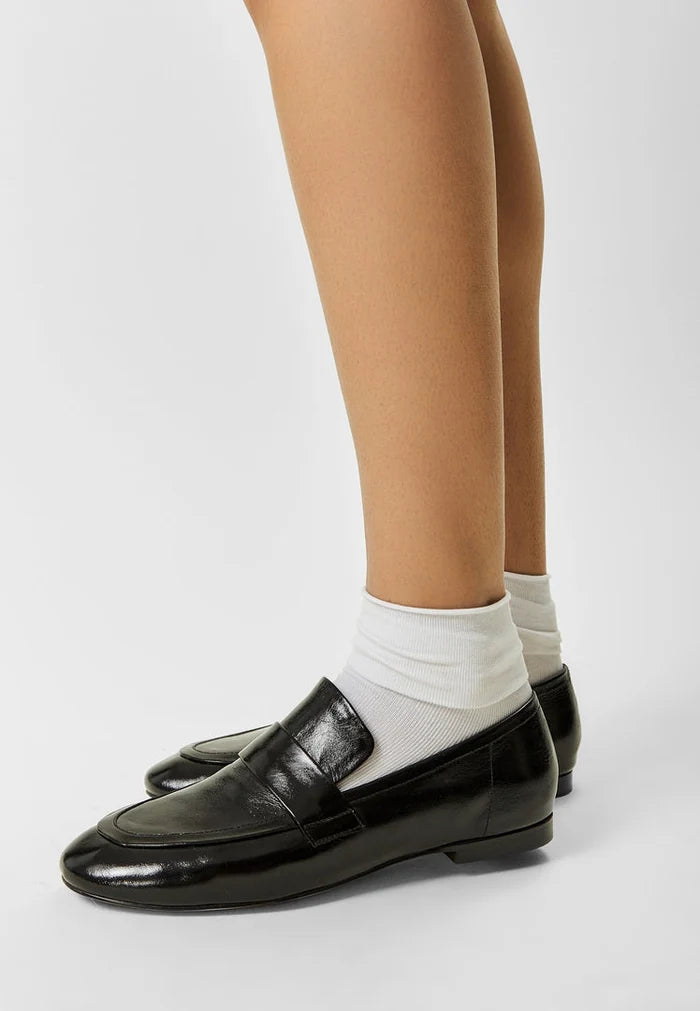 A trendy pair of black block heeled Diana loafers for women, perfect for fall fashion.