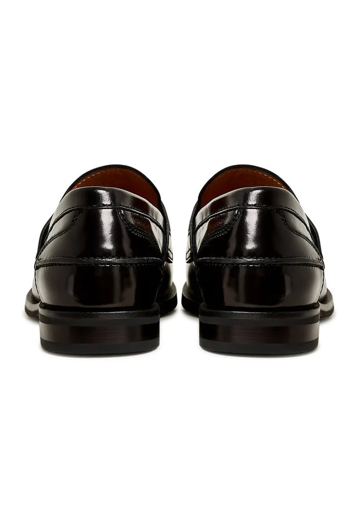 A chic pair of black leather block heeled loafers, the Dinara black shoes, perfect for any woman's wardrobe with their chunky heel design.