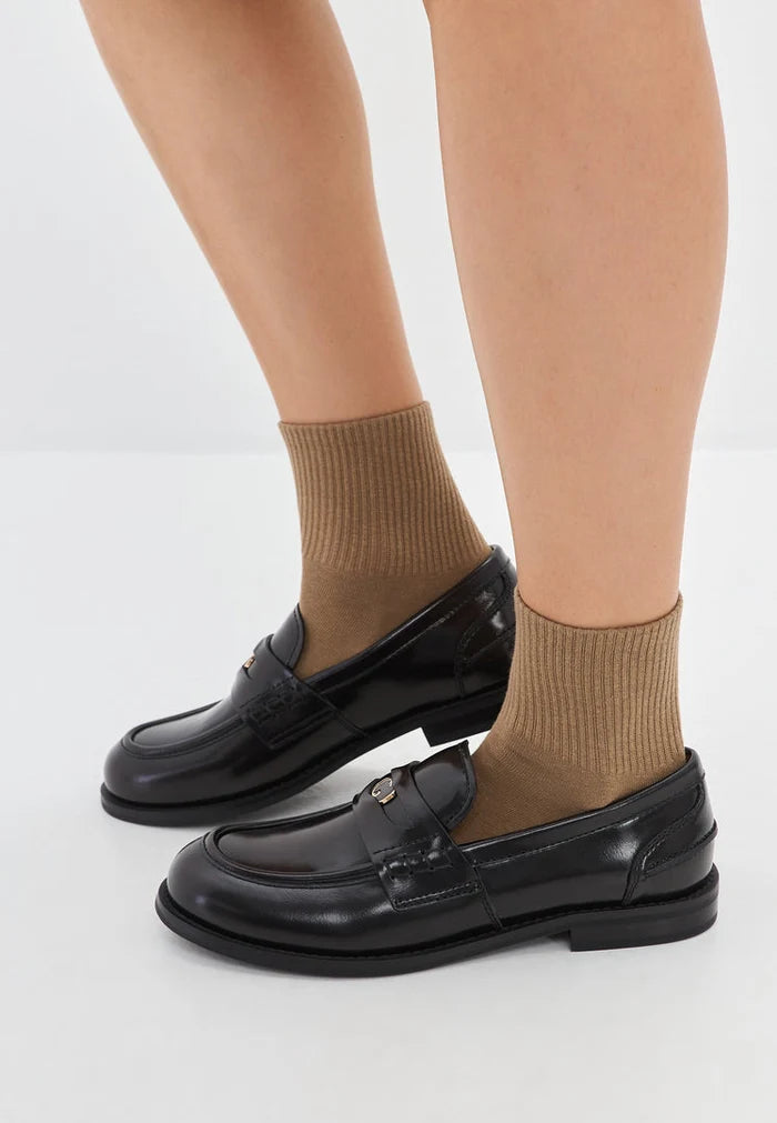 A stylish pair of black leather block heeled loafers for women, also known as Dinara black shoes, featuring a chunky heel design.