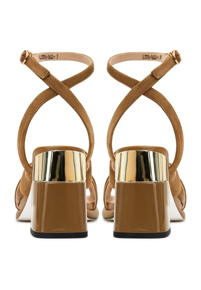 A stylish pair of beige block heeled Evelyn sandals for women, perfect for adding a trendy touch to your fashion-forward look.