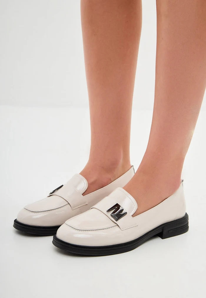 A chic pair of fashionable white block heel loafers for women, perfect for any stylish outfit with their slip-on design.