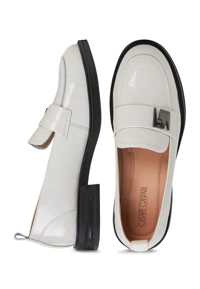 A stylish pair of fashionable white block heel loafers for women, perfect for slip-on style.
