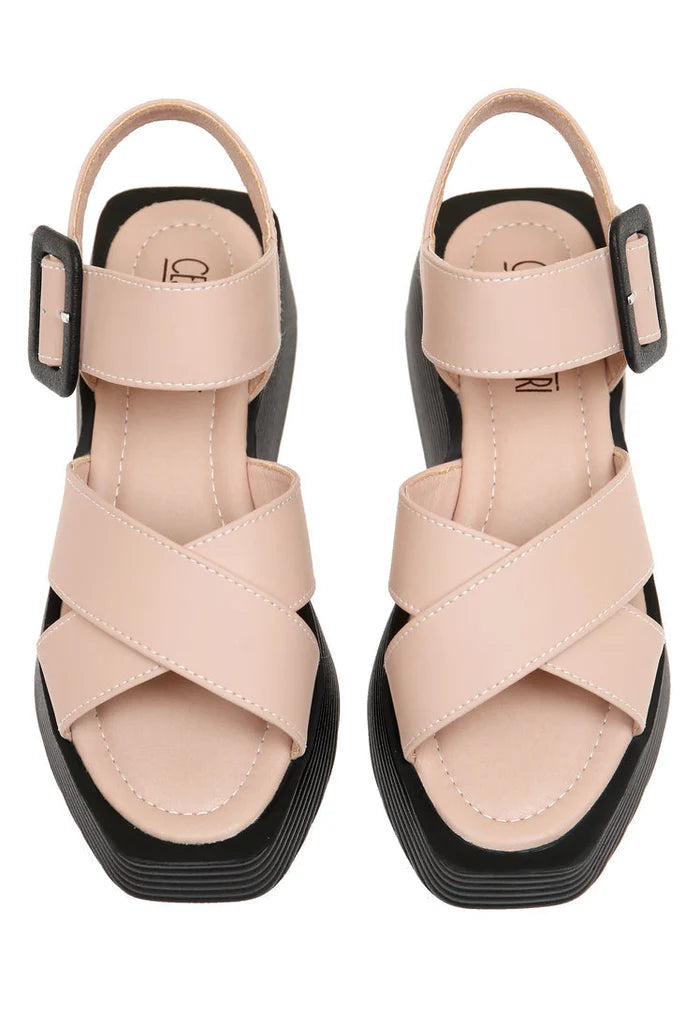 A stylish pair of women's blush pink platform sandals with high heels and strappy details.
