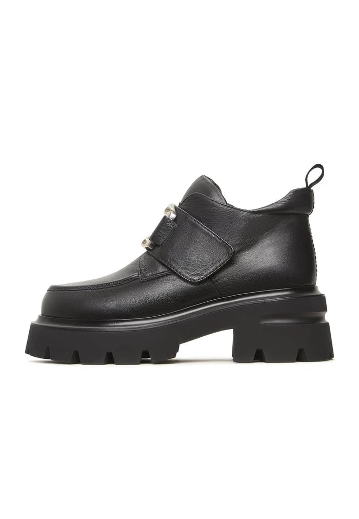 A stylish pair of black leather double buckle Geirr loafers, a bold choice in men's fashion footwear.
