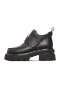 A stylish pair of black leather double buckle Geirr loafers, a bold choice in men's fashion footwear.