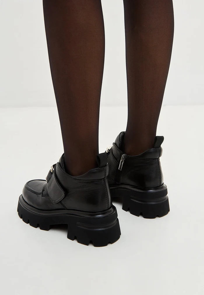 A pair of sleek black leather Geirr double buckle loafers, a bold choice in men's fashion footwear.