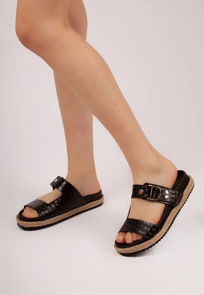 A stylish pair of women's black buckle strap slide sandals for a casual and chic look.