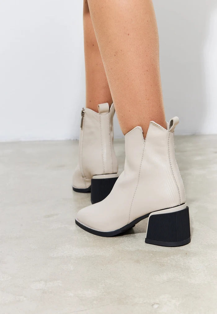 A stylish pair of beige casual ankle boots for women, perfect for fashion-forward looks while providing all-day comfort.