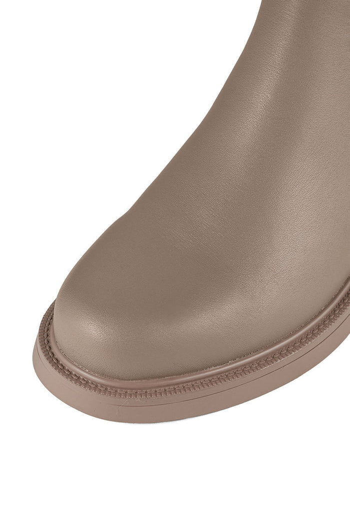 A stylish pair of beige ankle boots, perfect for women's fashion with a casual block heel that adds a trendy touch to your outfit.