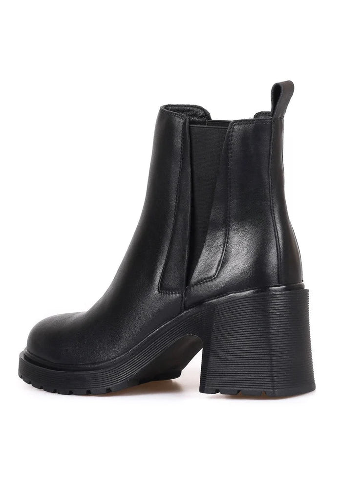 A stylish woman wearing trendy ankle boots - a blend of casual and classic design, perfect for women looking for fashionable footwear.