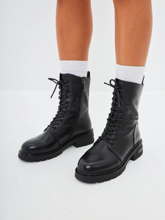 A stylish pair of black leather ankle boots featuring a block heel, perfect for a casual yet chic look.
