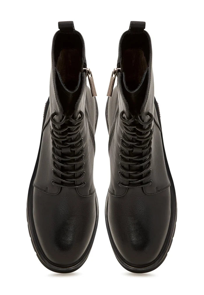 A close-up image of stylish black leather ankle boots with a block heel, perfect for a casual and chic look.