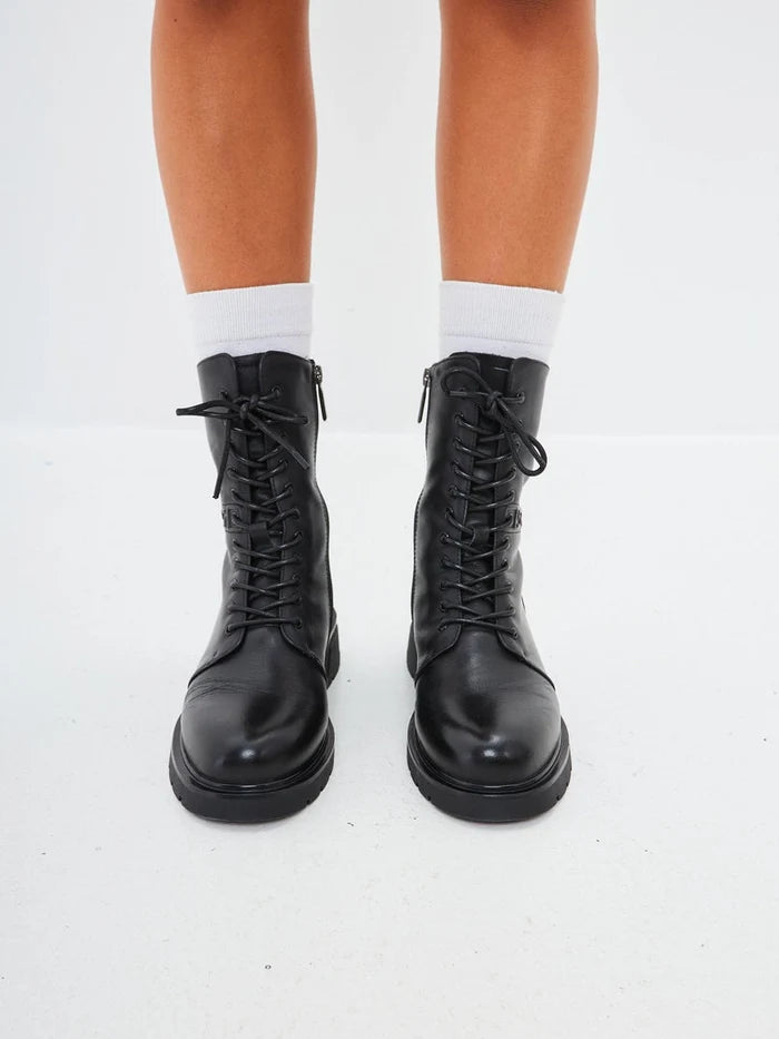 A close-up image of stylish black leather ankle boots with a block heel, ideal for everyday wear as casual boots.