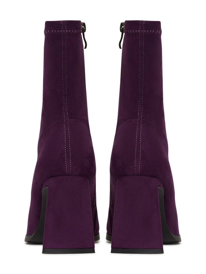 A pair of stylish purple suede ankle boots with a block heel, ideal for casual wear.