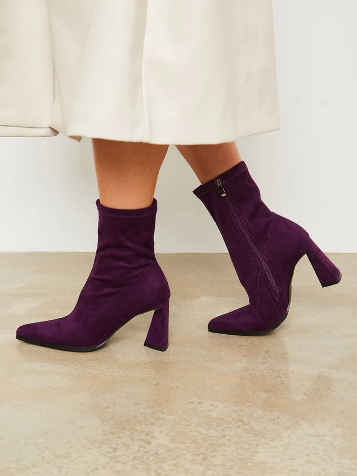 A pair of stylish purple suede ankle boots with a trendy block heel, perfect for casual wear.