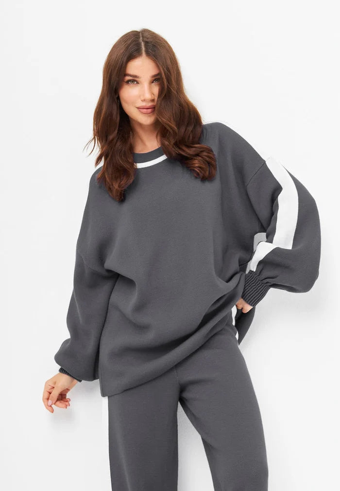 A coordinating knitted jogger set in a cozy grey color, perfect for lounging in style with this comfortable and casual loungewear outfit.