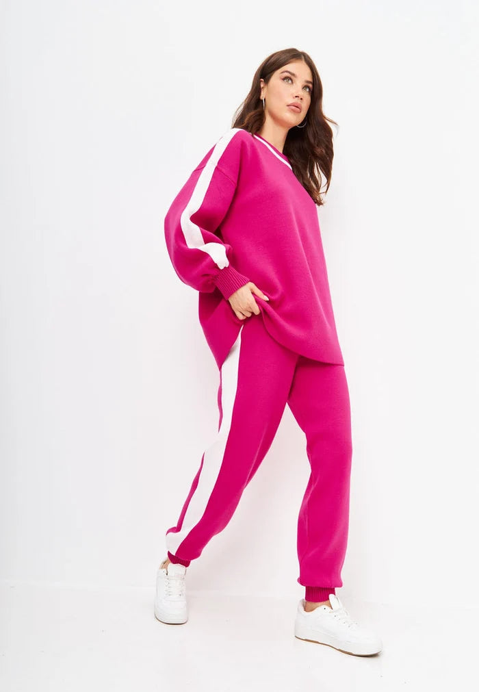 A stylish pink knitted jogger set, perfect for a casual knitwear outfit, featuring a coordinating top and bottom for women.