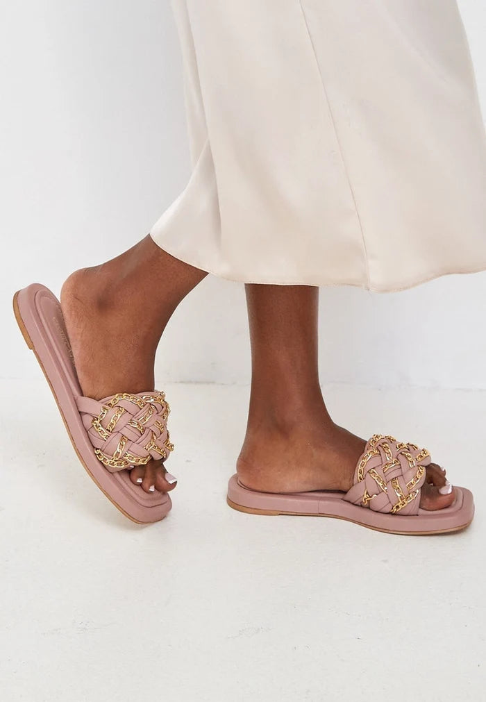 A pair of stylish beige chain leather sandals for women, perfect for elevating any summer outfit.