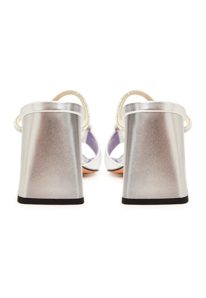 A pair of silver high heel sandals with a chic and trendy design, featuring a unique backless style known as Rosalia heels.