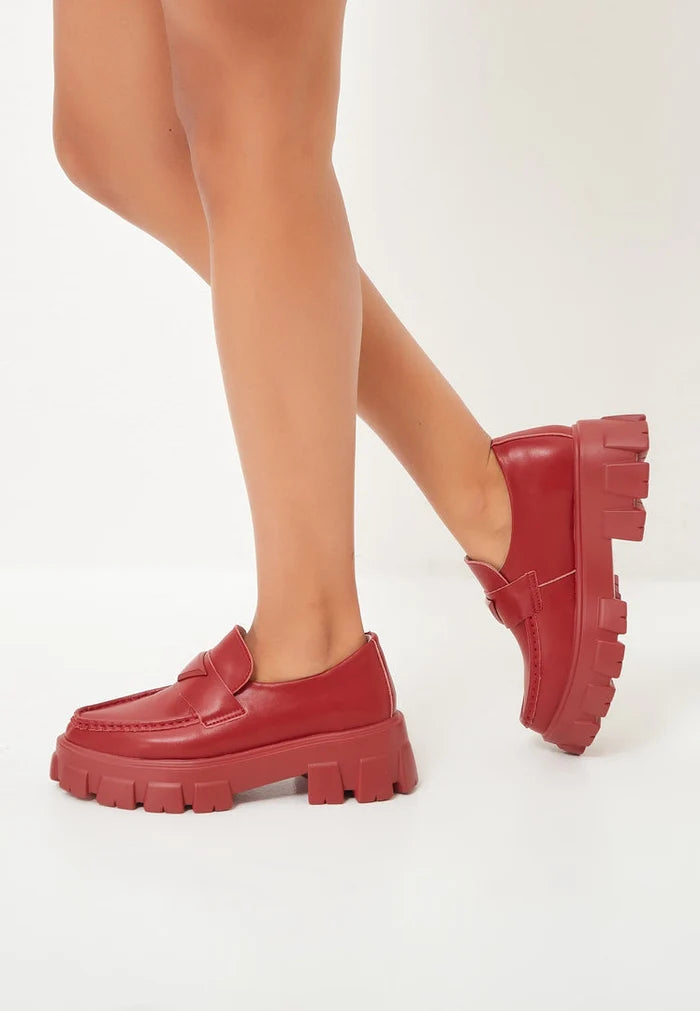 A stylish pair of chunky leather platform loafers in a rich bordeaux color, perfect for adding a trendy touch to any outfit.