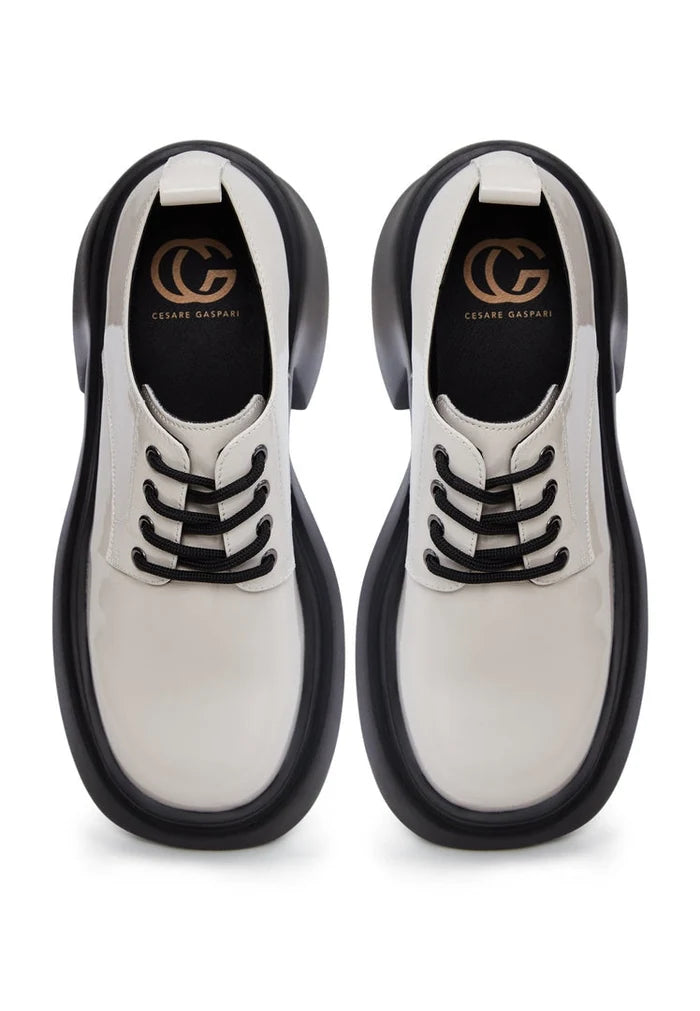 A trendy pair of chunky white loafers, perfect for a fashion-forward woman's shoe collection.