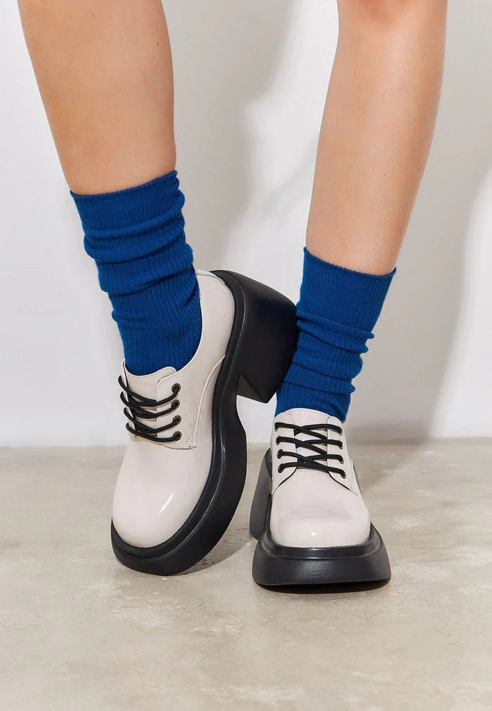 A stylish pair of white chunky loafers, perfect for adding a touch of fashion-forward flair to any outfit.