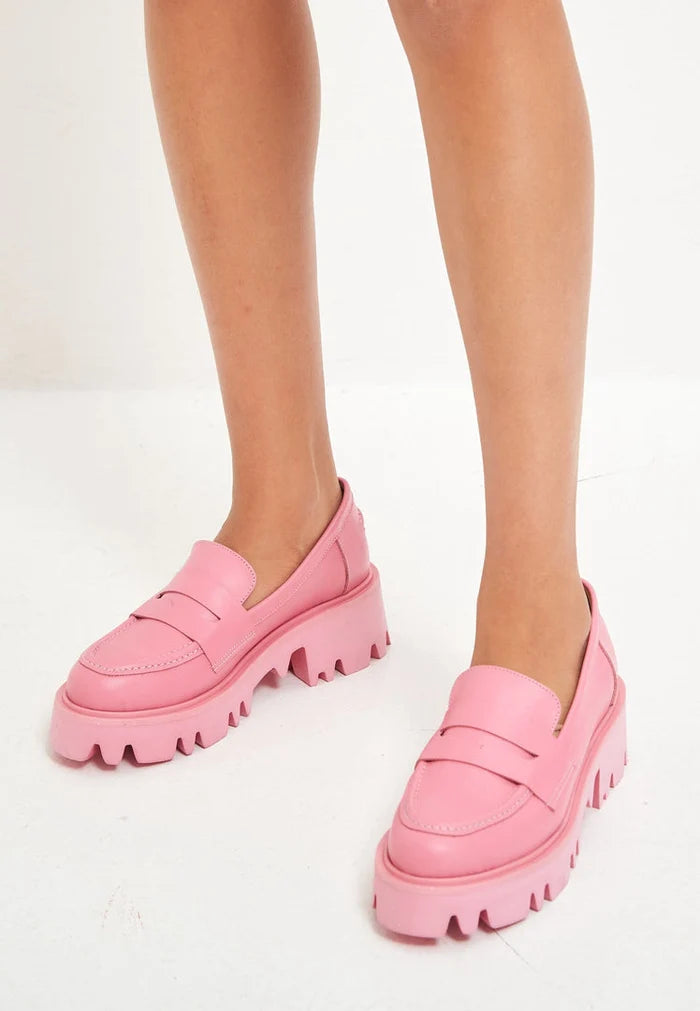 A stylish pair of chunky platform loafers in trendy pink, perfect for women's footwear fashion enthusiasts.