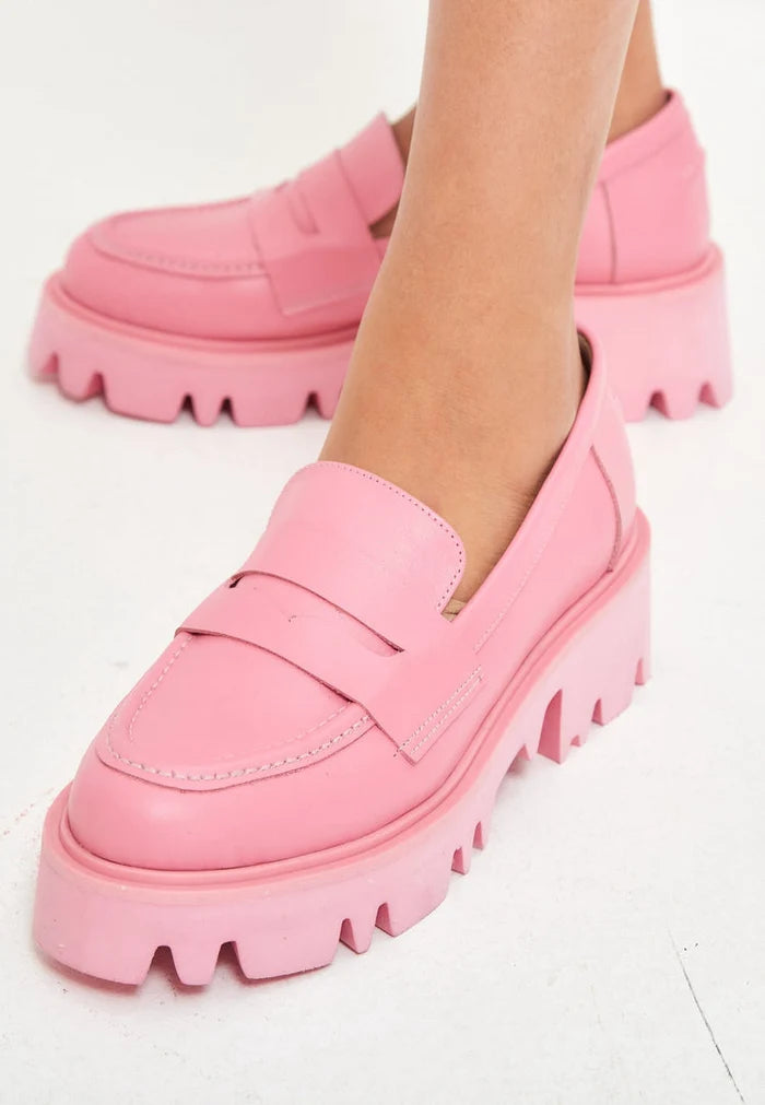A pair of trendy pink chunky platform loafers for women's footwear fashion.