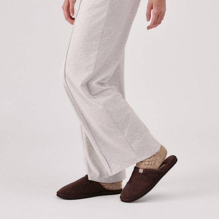 Side view of Classic Brown Terry slipper on model showcasing slim terry upper and thin Vibram sole against white background