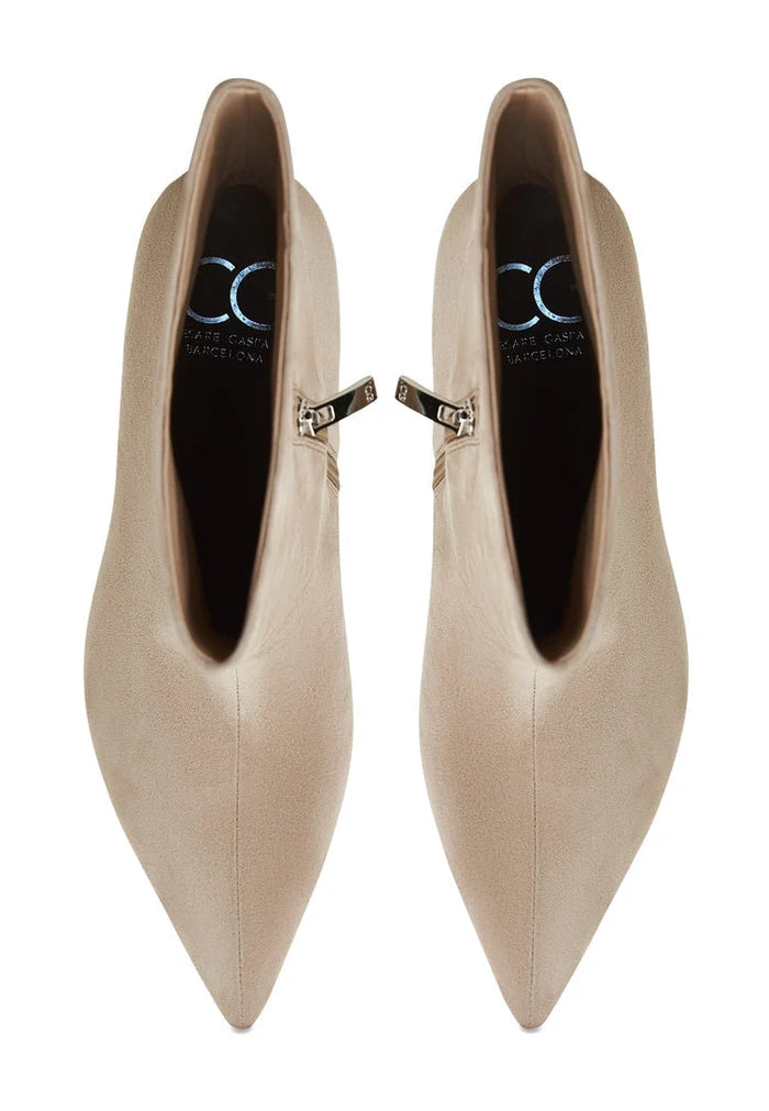 A stylish pair of classic ankle boots in beige, known as Regina boots, for women - fashionable designer footwear.