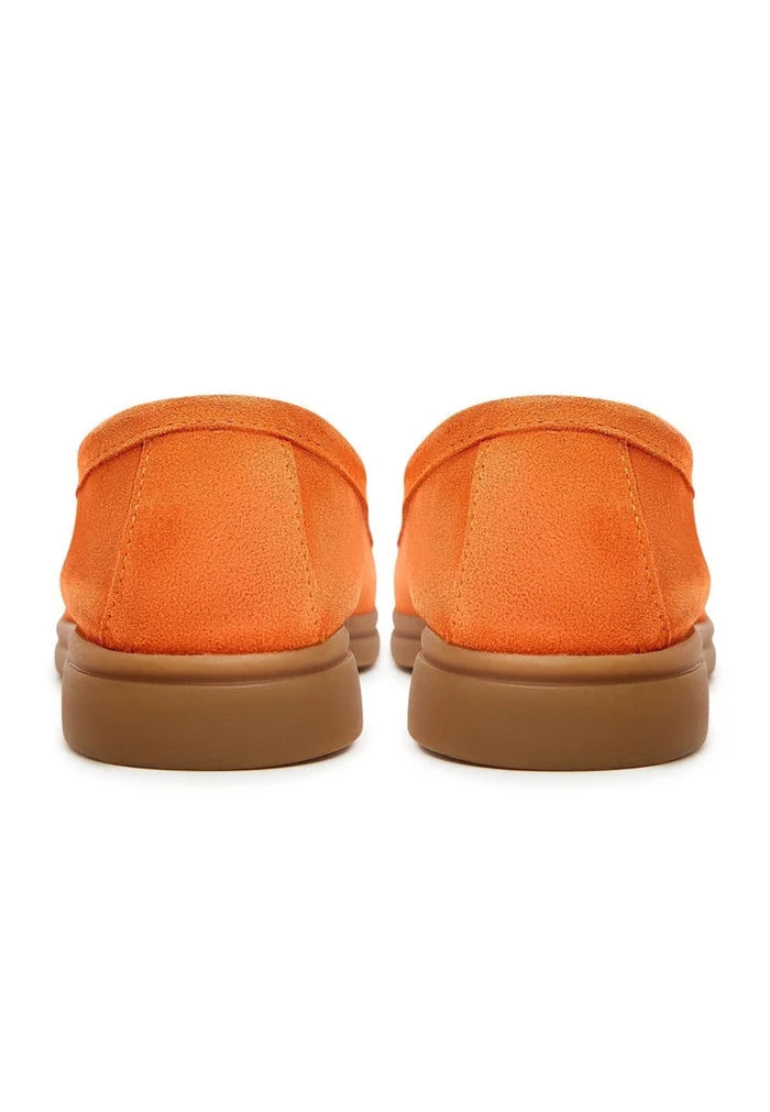 A stylish pair of men's classic orange loafers with a flat sole, perfect for adding a pop of color to any outfit. Ideal for those seeking fashion-forward footwear.