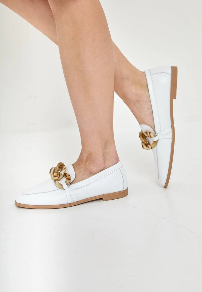 A pair of classic white leather loafers with a flat sole, ideal for any stylish outfit.
