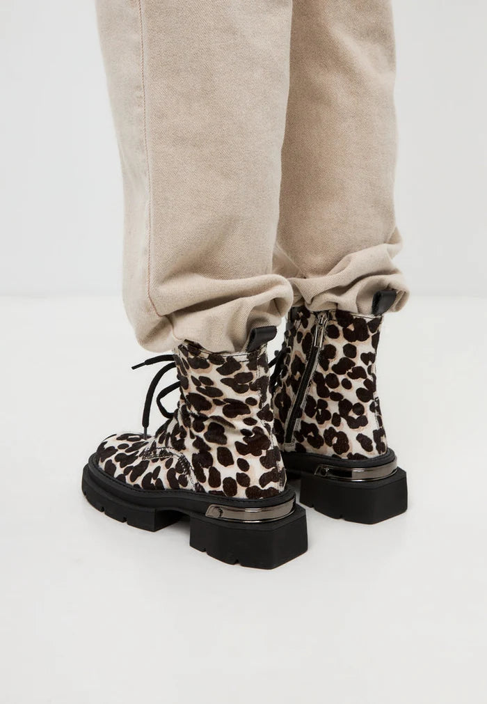 A stylish pair of classic leather platform ankle boots with a trendy leopard print design, perfect for any fashion-forward outfit.