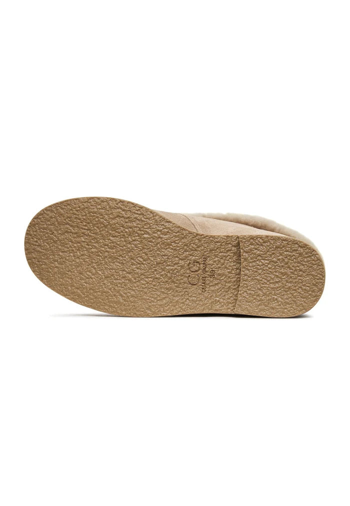 A cozy pair of Gerda beige suede fur-lined boots, perfect for keeping warm during winter.