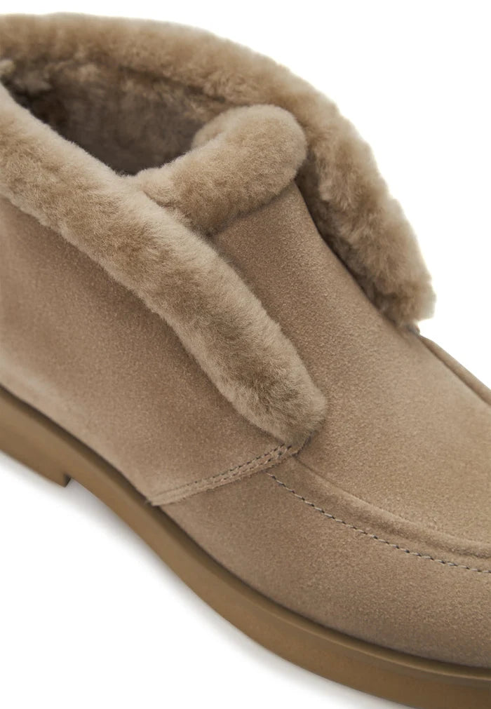 A pair of cozy Gerda beige suede fur-lined boots for women, the perfect warm winter footwear.