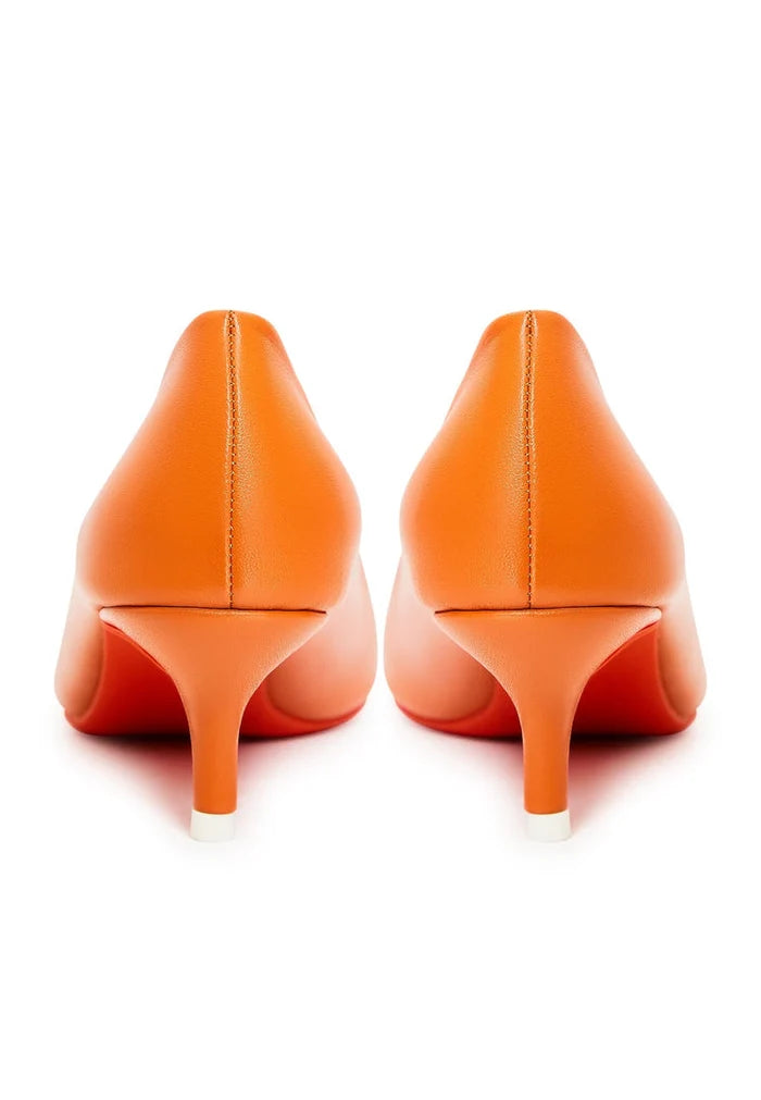 A pair of elegant orange designer pumps, high-end footwear for a luxurious look.