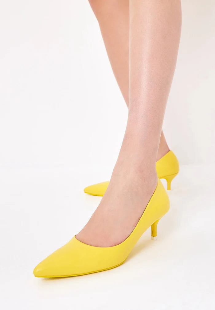A pair of luxurious yellow pumps, the epitome of elegant footwear and designer heels, representing high-end shoes.