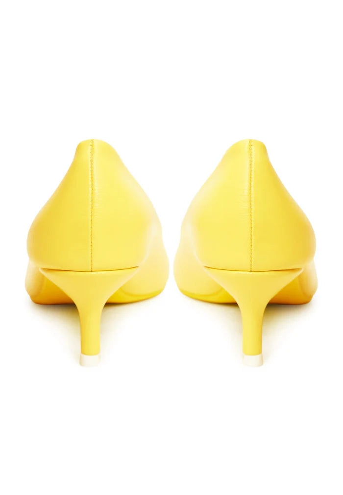 A pair of luxurious yellow pumps, the epitome of elegant footwear and designer heels for those seeking high-end shoes.