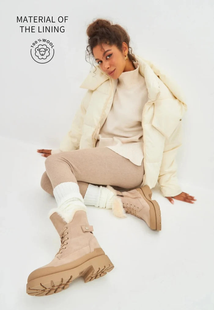 A pair of fashionable beige suede ankle boots, the epitome of elegant and stylish footwear.