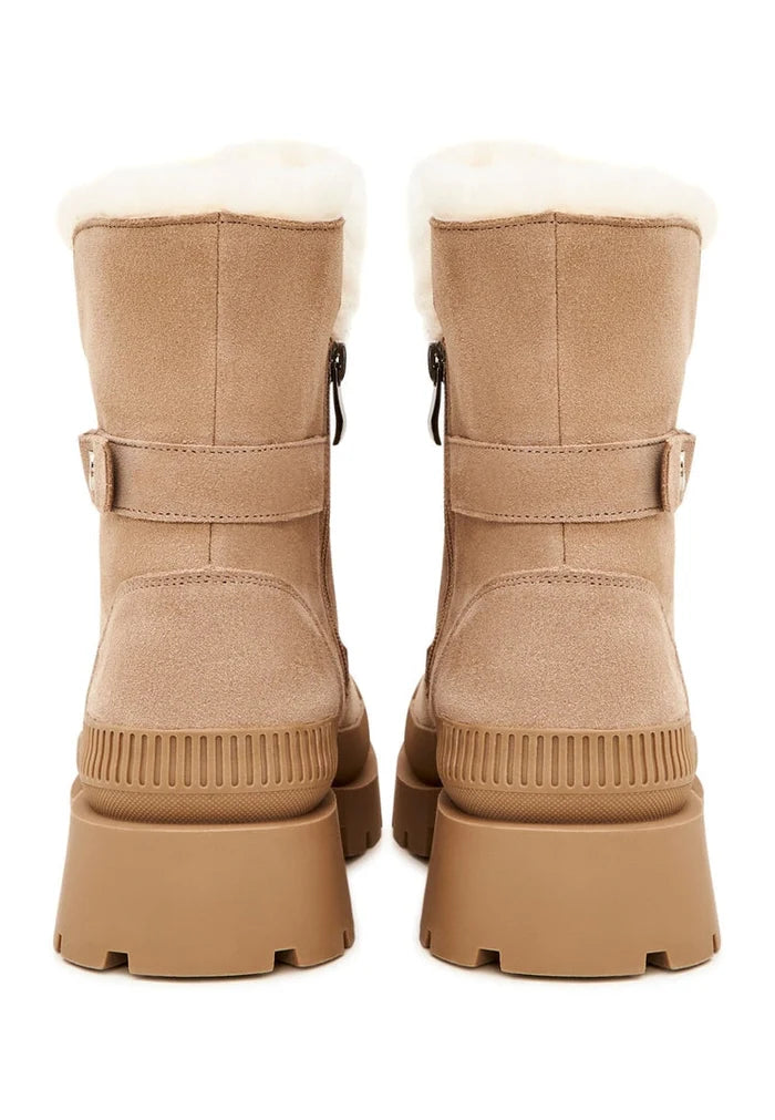 A pair of stylish beige suede ankle boots, the perfect elegant and fashionable footwear choice.