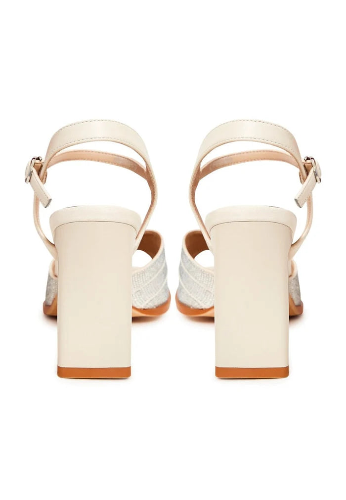 A pair of stylish beige sandals, perfect for adding elevated elegance to any outfit.