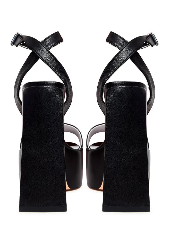 A pair of elegant black sandals with an elevated design.