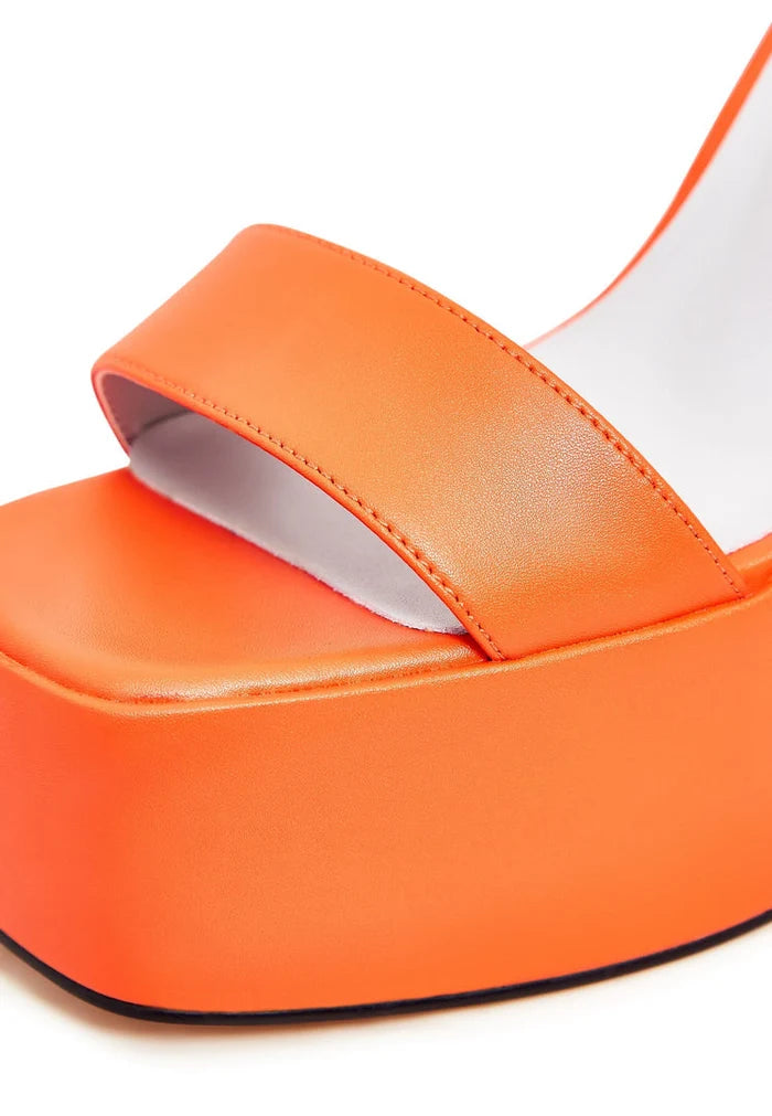 A pair of elegant orange high heel sandals, perfect for women's fashion, showcasing sophisticated footwear.