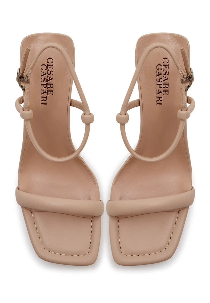 Pair of elegant beige women's dress shoes, featuring stylish heels for elevated elegance - high-end designer footwear.